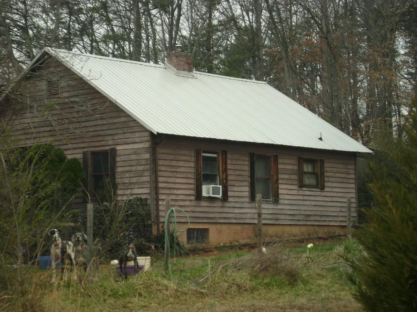 White metal roof on an old wood sided farmhouse, from a Metal Roof Installation job in Sierra Vista
